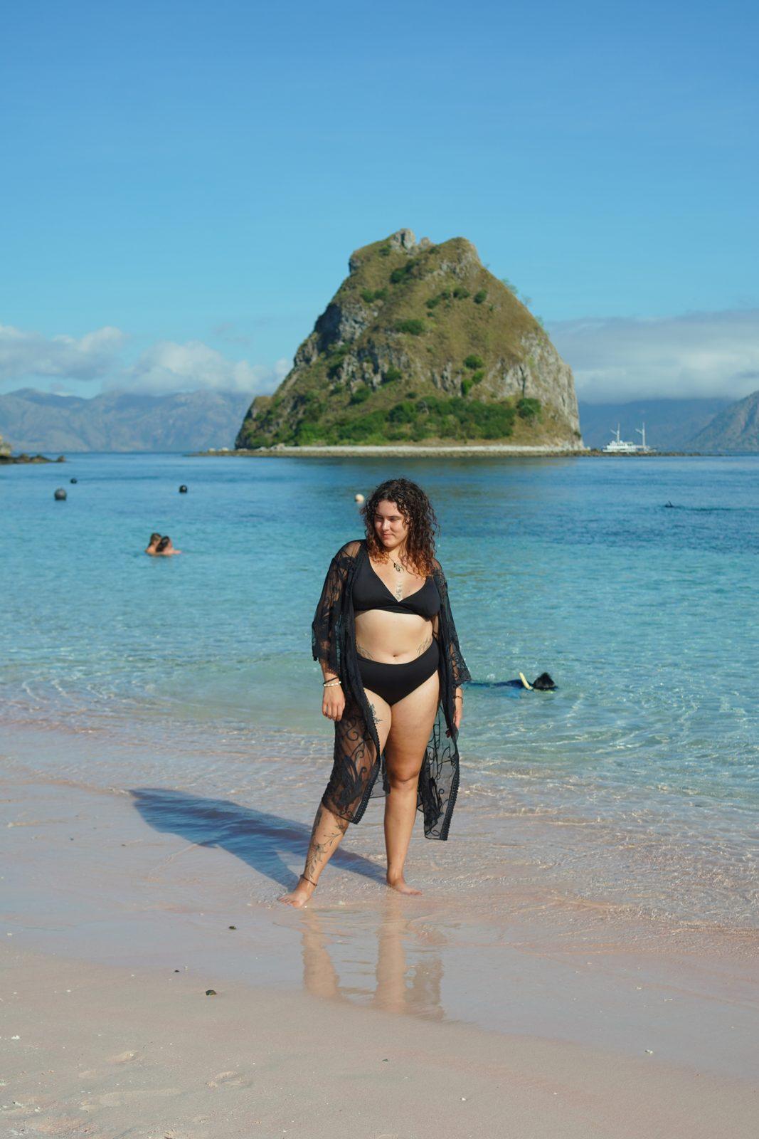 Kelor – woman in black cover-up on sand, islet (Real photo from a KEXI trip)