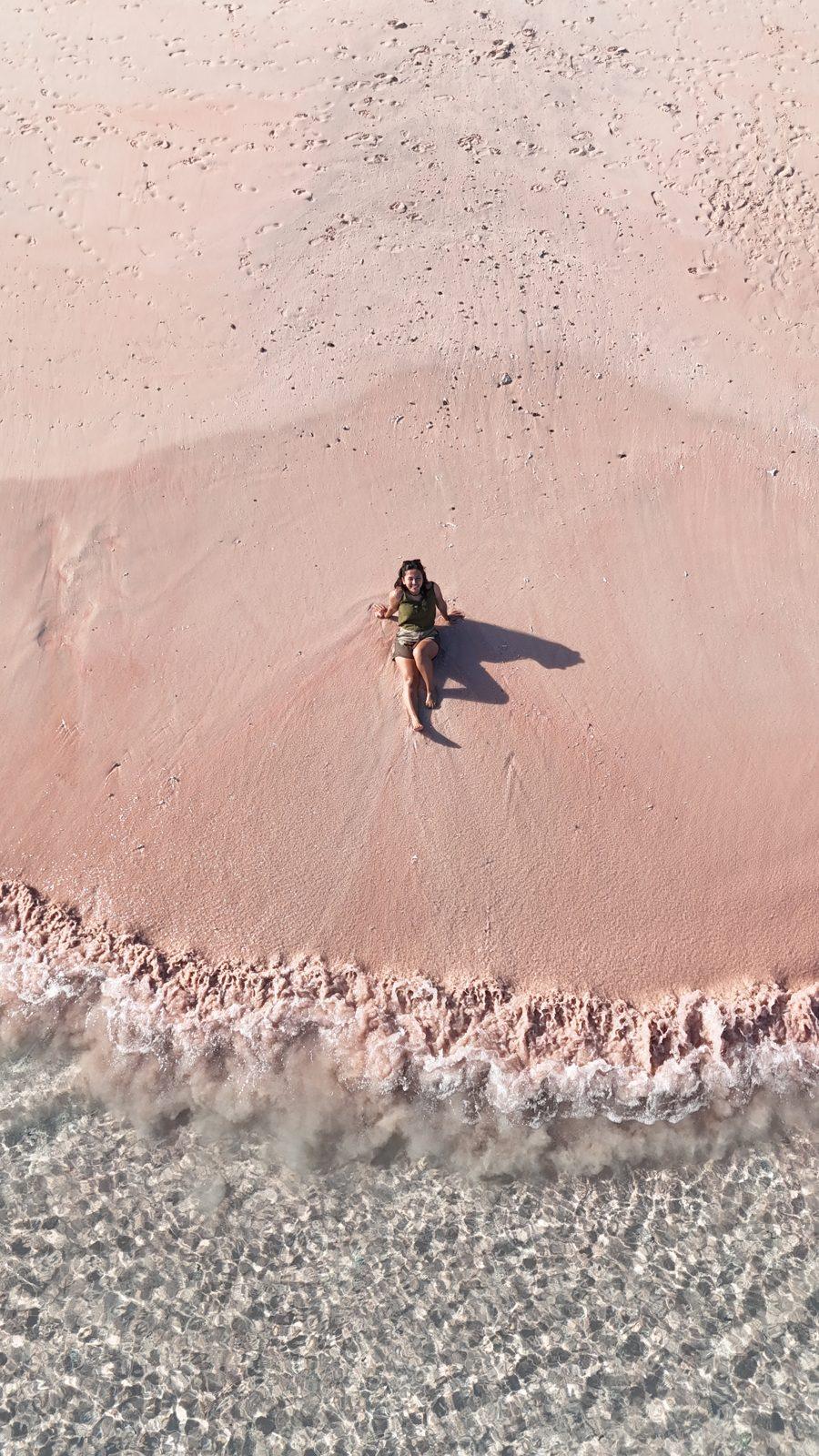 Pink Beach – lone figure on pink sand, turquoise water (Real photo from a KEXI trip)