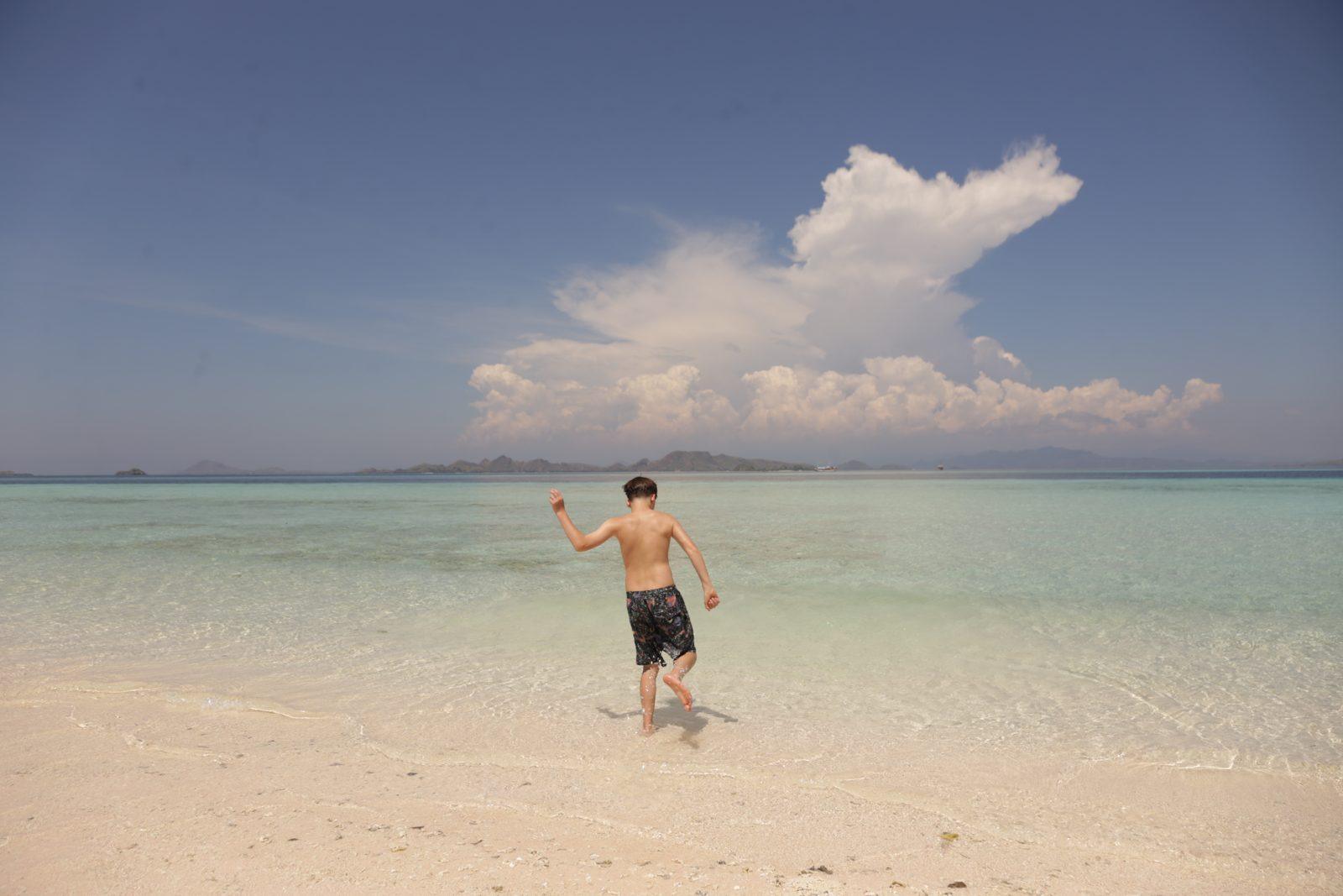 Taka Makassar – man walking on sandbar, cloud behind (Real photo from a KEXI trip)